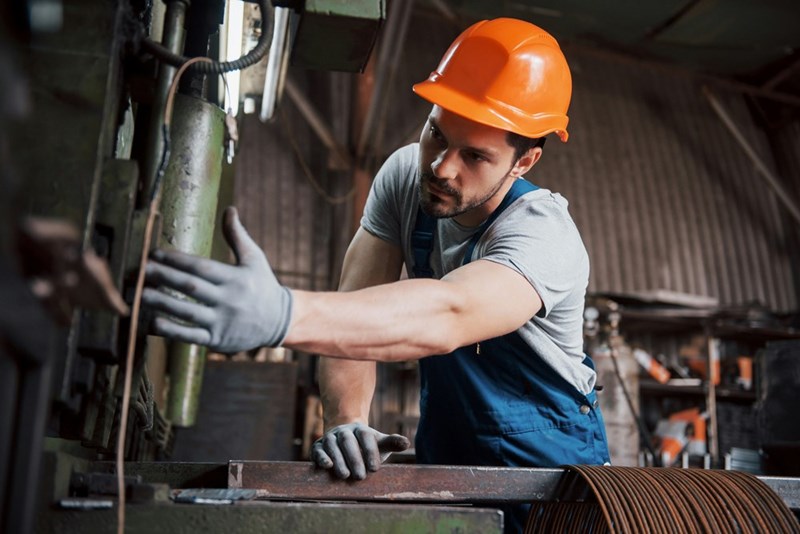 Worker reaches for tool during a long shift.