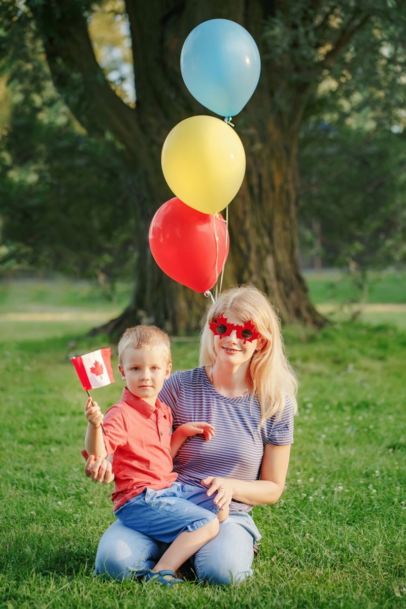 A mother is playing in her backyard with her toddler.