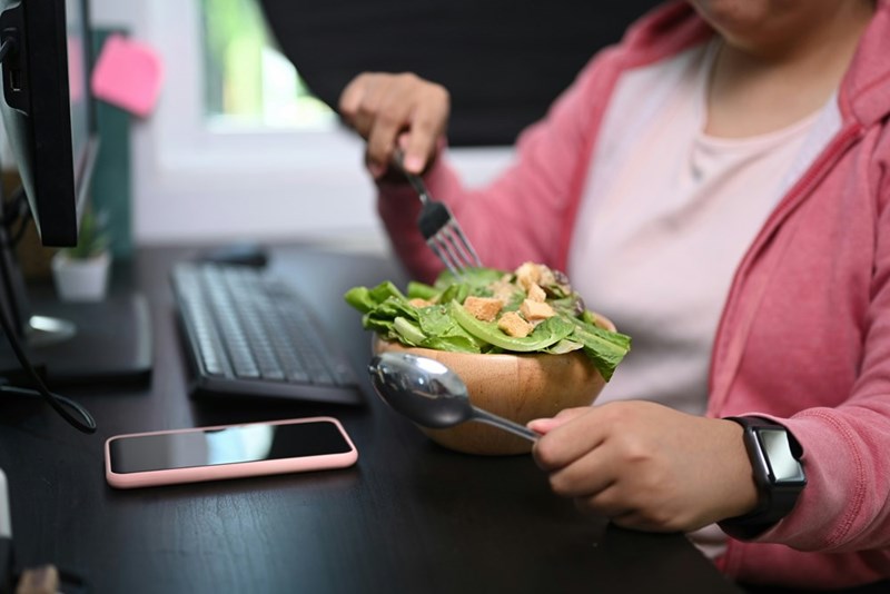Portrait of a woman having fresh salad at lunch