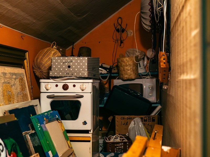 A cramped apartment storage unit filled with personal items.