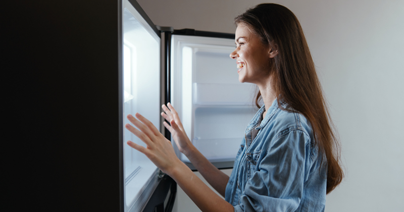 Woman who is happy with her new fridge purchase. 