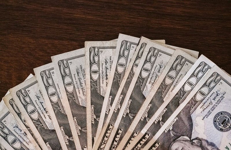 A spread of $20 bills that an employee is wondering how to spend.