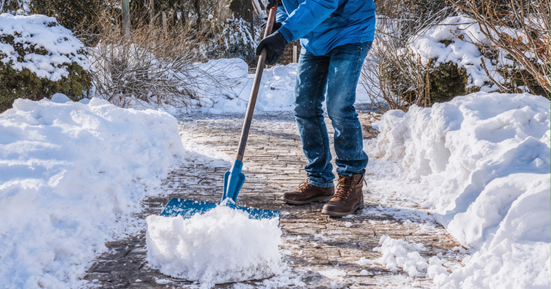 Shoveling snow during a blizzard.
