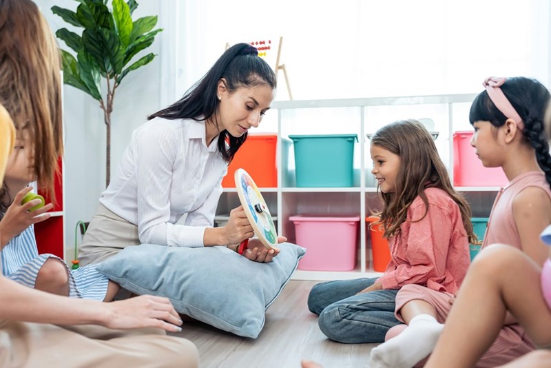 Mom plays with daughter and her friends at a sleepover party.