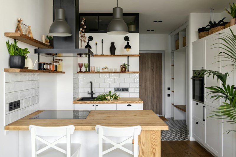 A bright, modern kitchen with wooden accents, open shelves, and a clean, minimalist design.