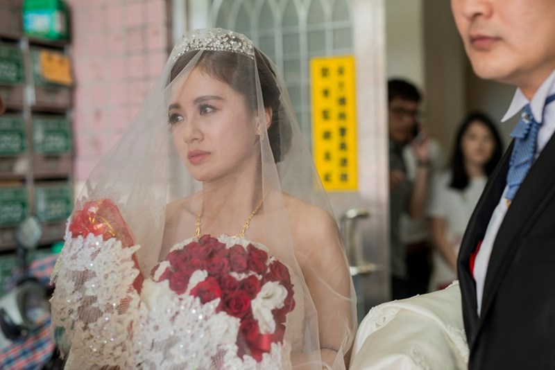 A bride looks upset at the altar, surrounded by flowers