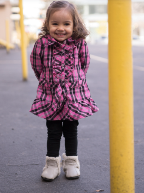 Cute little girl smiling at her mom.