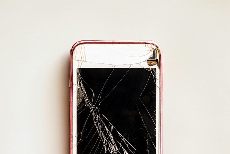 A broken cell phone sitting on top of a table