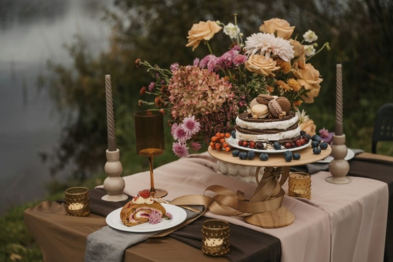 Beautiful professional wedding cake on a decorated table with sweets and baked goods