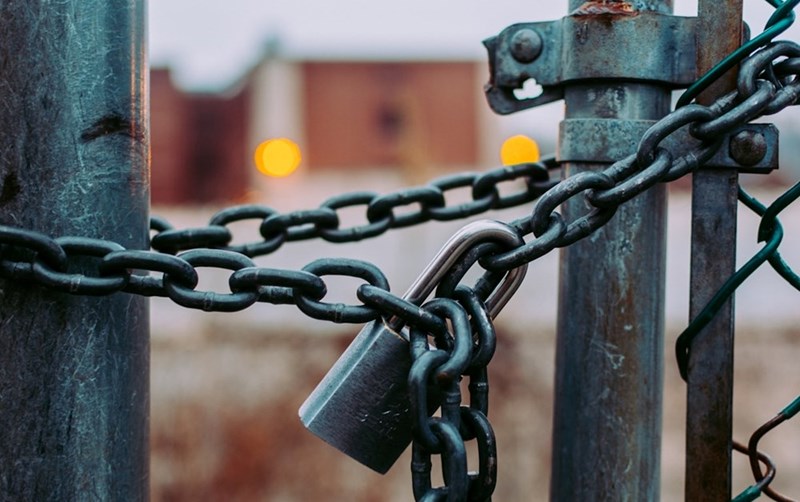 A close shot of a padlock chaining two fences