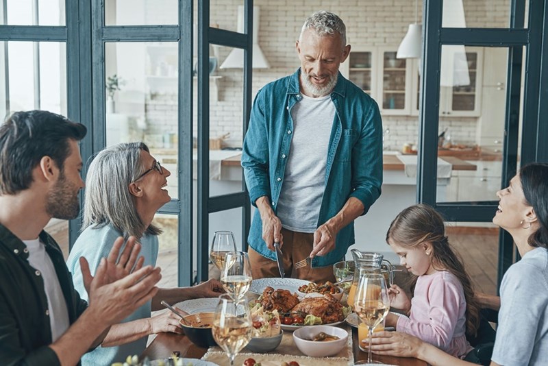 Large family is sitting down and having dinner together