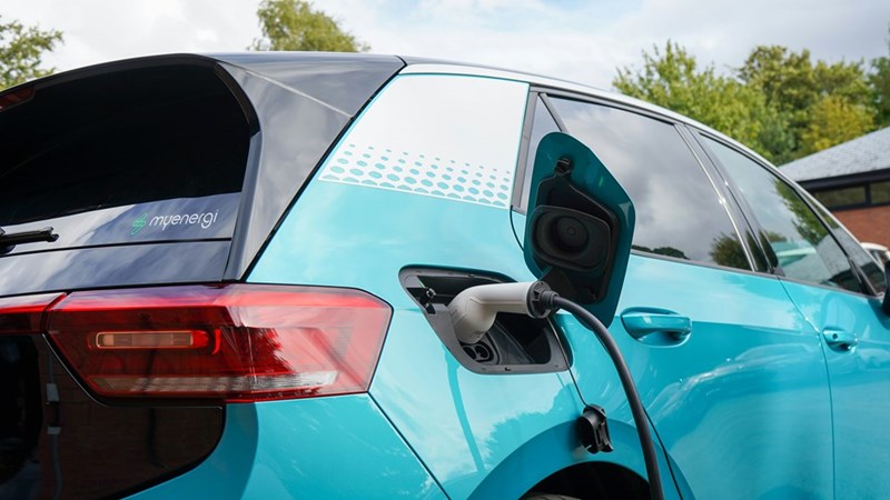 A teal electric car charging