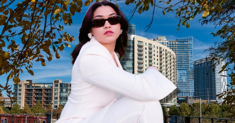Rich woman sits with a pouty expression in front of her Chicago condo building.