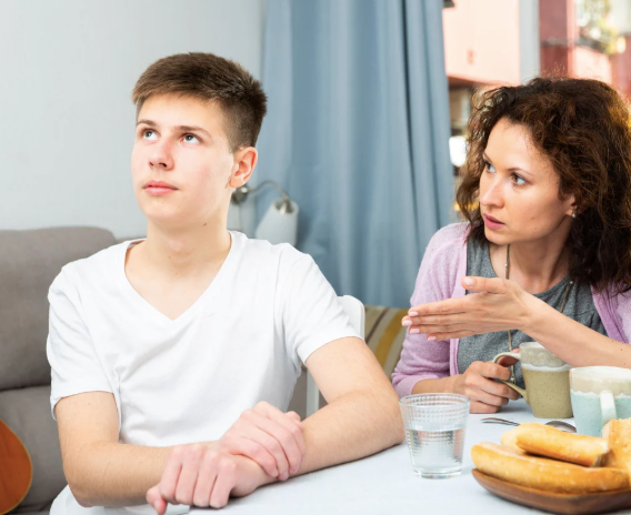 Mother scolding her teenaged son when he doesn't listen to her.