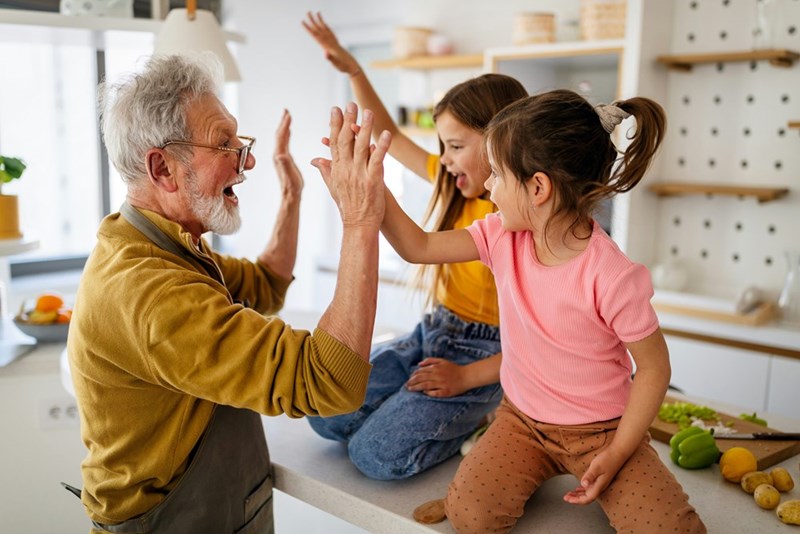 Happy grandparents having fun times with grandchildren at home