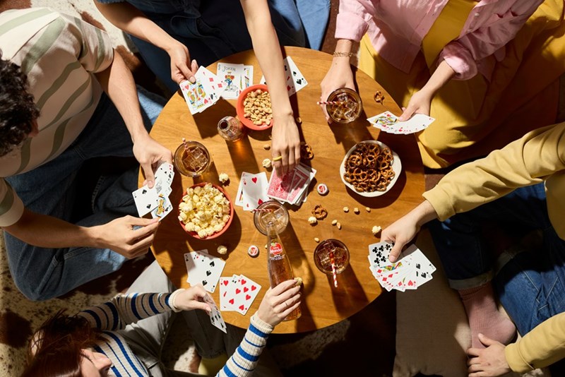Casually dressed friends play board games on a round table