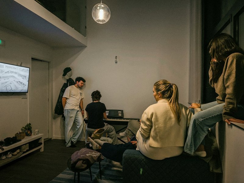 Casual group of friends hanging out in the living room and talking