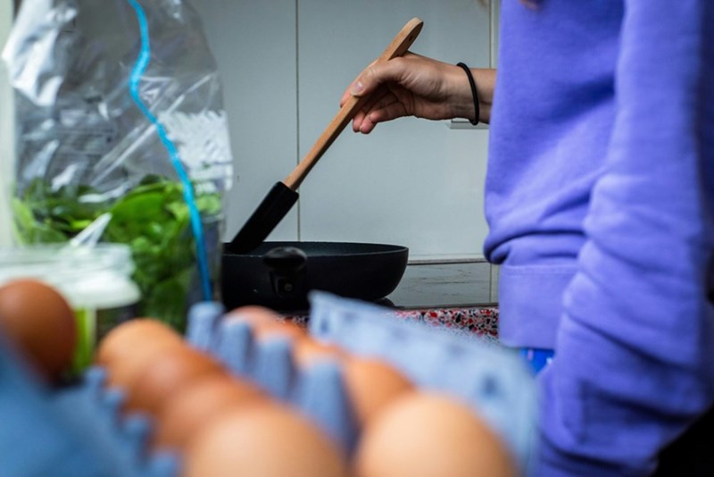 Woman making eggs for breakfast in the kitchen