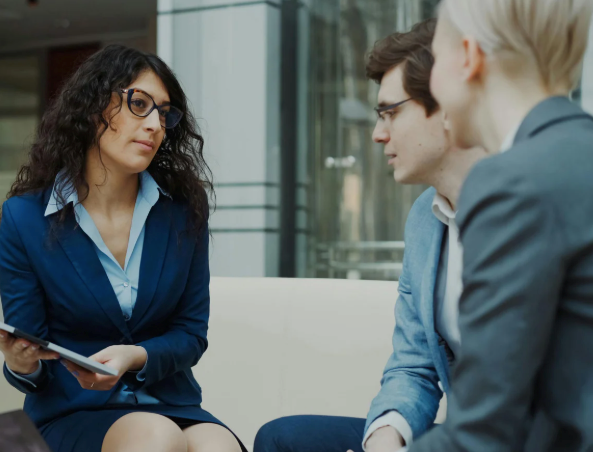 Employees having a serious discussion about workplace etiquette.