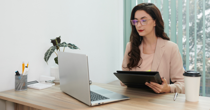 HR Manager Checking CVs with Laptop
