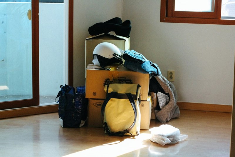 Packaged belongings on the floor of a house.