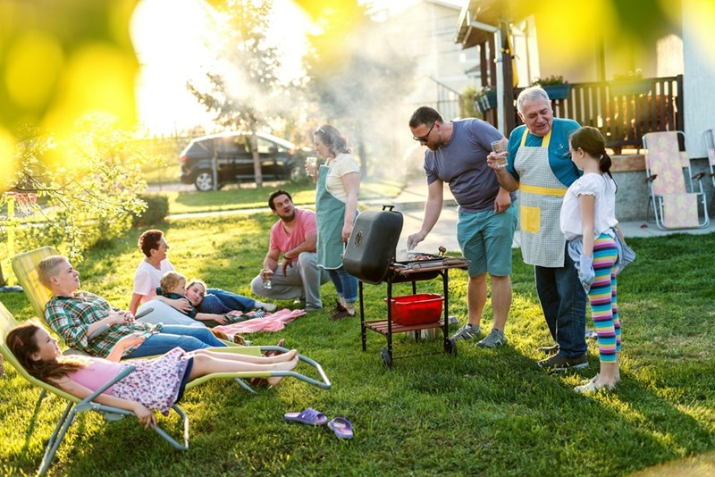 A family enjoying time they spend together during a backyard barbecue