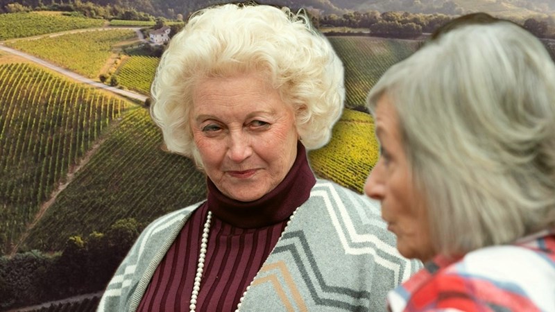 An elderly woman stares intensely at her neighbor