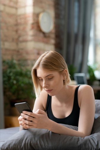 Woman reading messages from her home in her house.