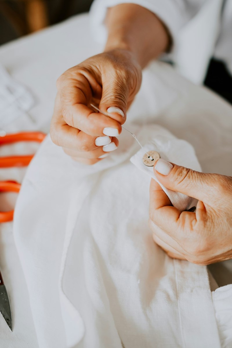 Tailor woman fixing wedding dress.