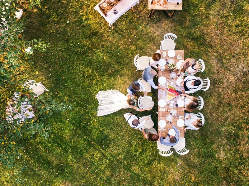 Couple having a small backyard wedding on a sunny day.