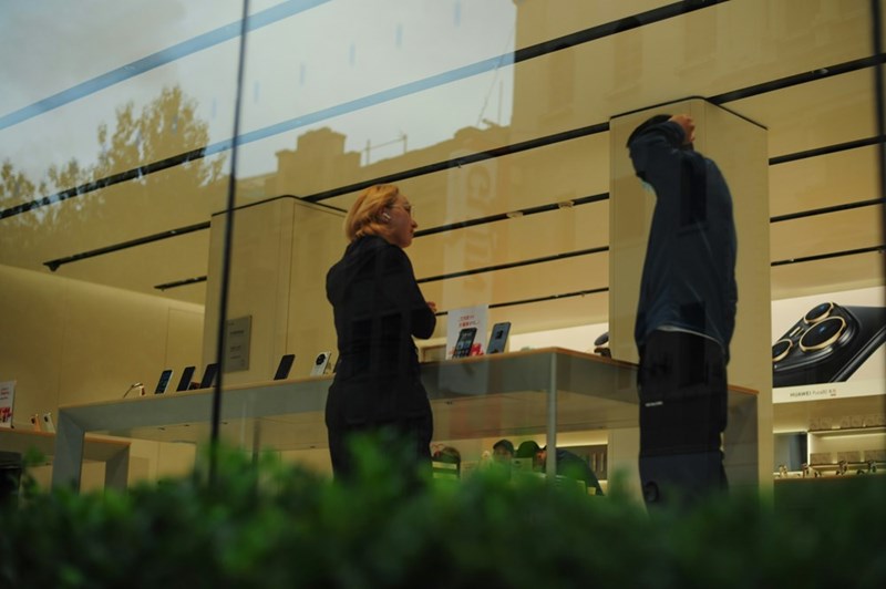 Two people talking inside an electronics store