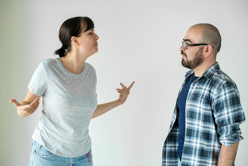 Couple arguing intensely during disagreement about boundaries in shared household