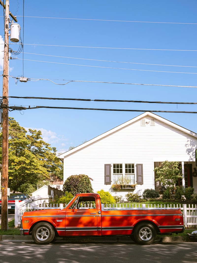 Giant truck parked in front of a house as a strategy to set boundaries with neighbors.