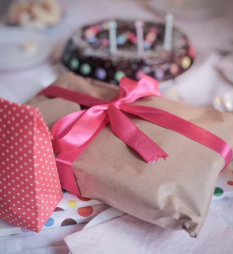A tablet phone device wrapped nicely as a birthday gift.