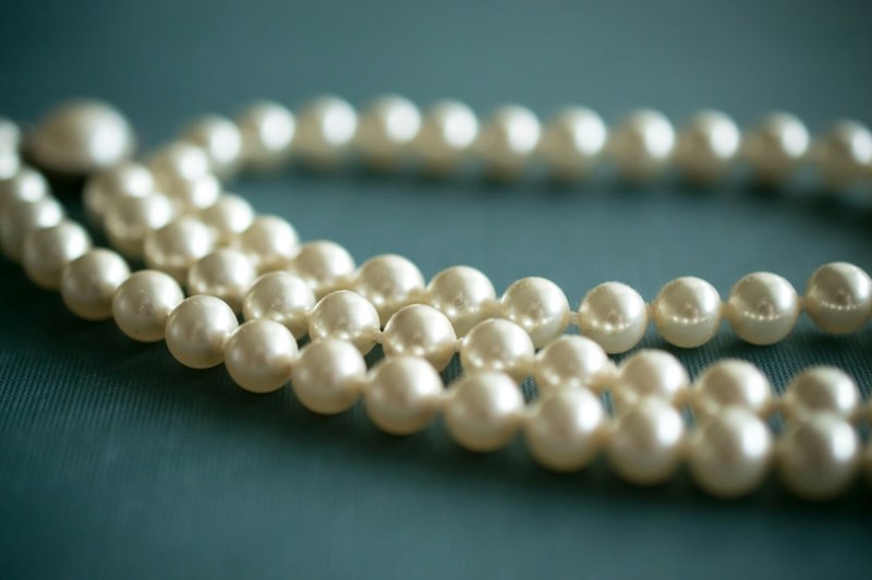 White pearls on a grey textile.