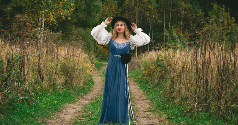 Renaissance Woman in Blue Dress in Forest Setting