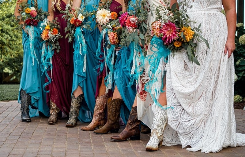 Bridesmaids wearing cowboy boots for the ceremony.