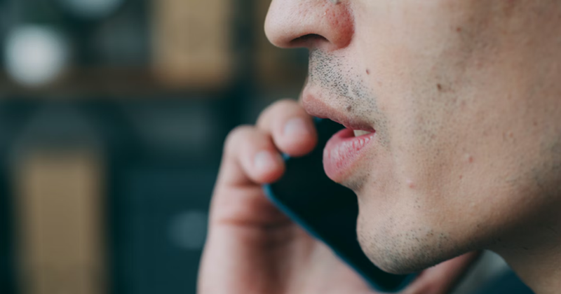 Close-up person talking over the cellphone.