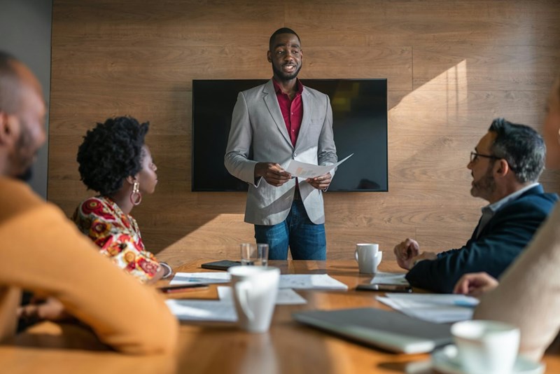 Employee nervously gives presentation to his peers and bosses.