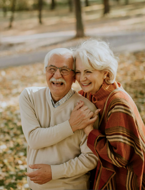 Elderly couple embracing in the park
