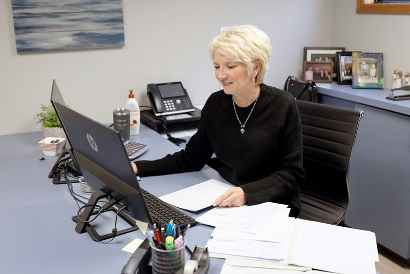 Woman works on a laptop at her office desk