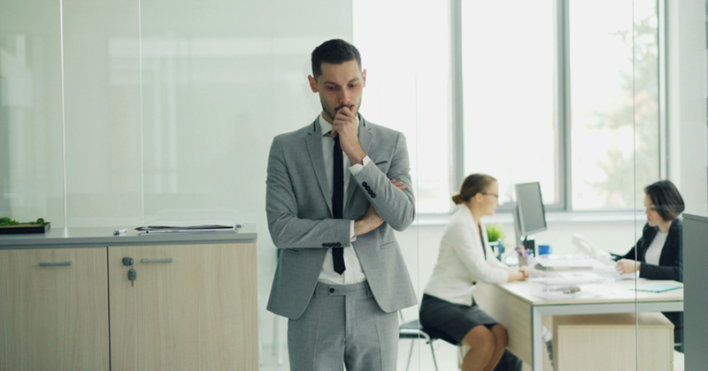 Businessman in Office Pondering Decision
