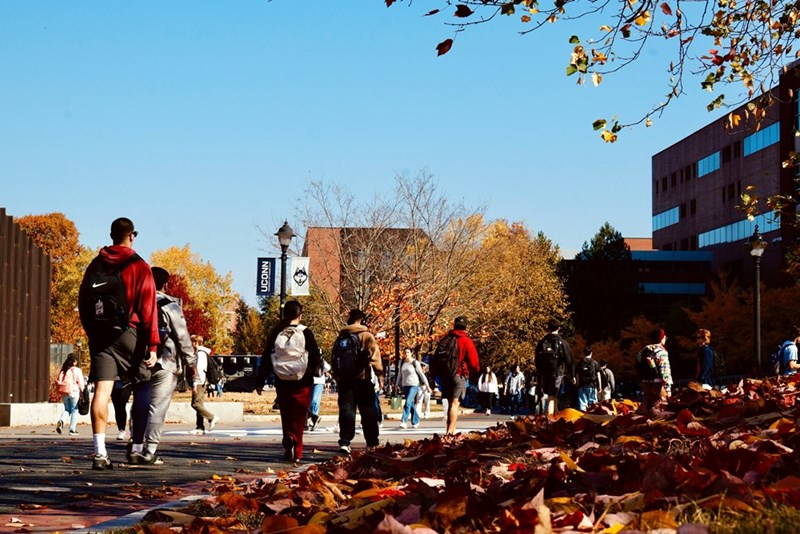 A group of people walking down a street