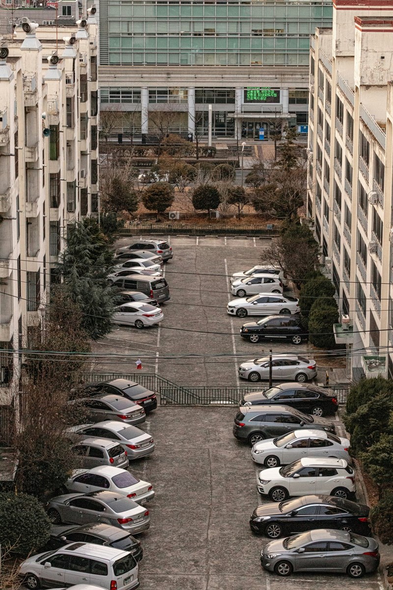 Full parking lot in an apartment building.