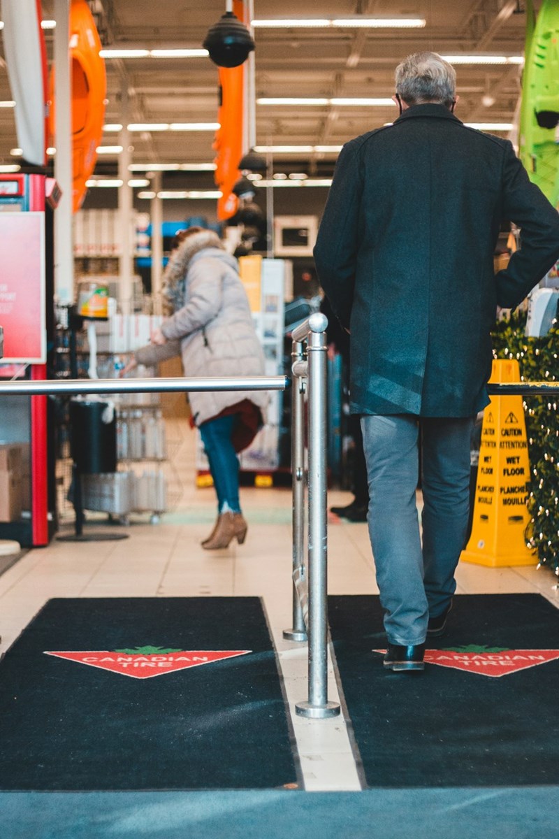 Entrance to grocery store where shoppers are coming in and out of