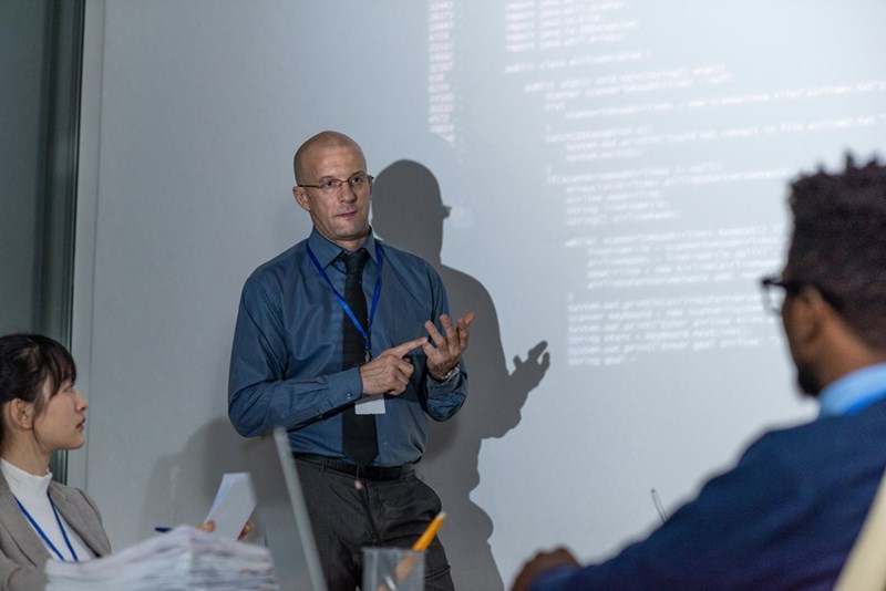 A professor lectures a group of students