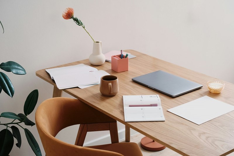 Relaxing home office space with laptop and journal.