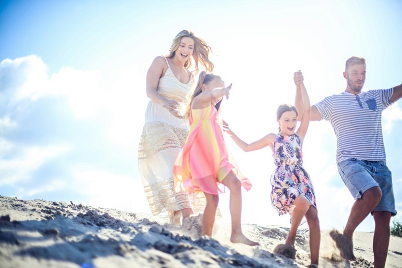 A family at a beach wedding