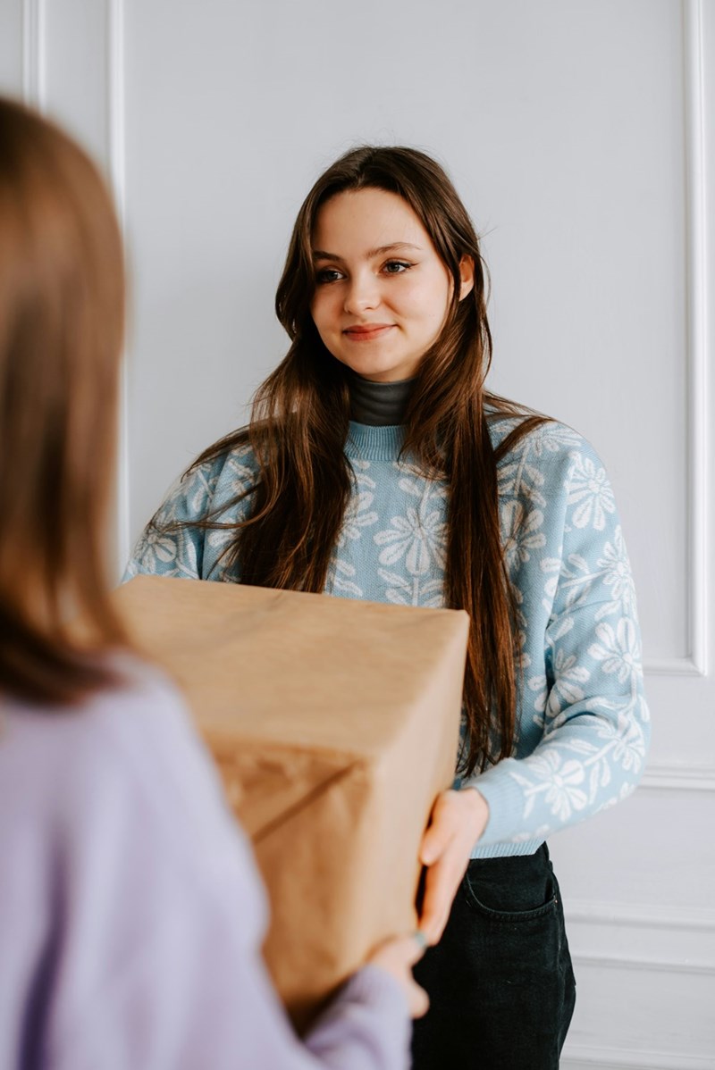 Girl receiving a gift she didn't ask for.