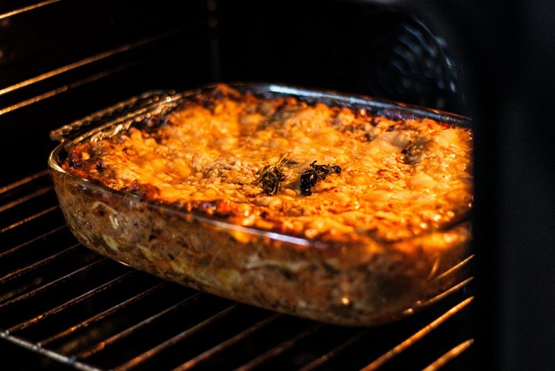 A tray with lasagna in the oven.